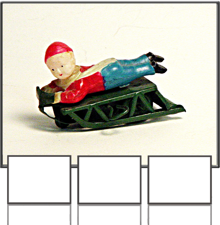 Boy lying on snow sleigh made in occupied Japan 1950s